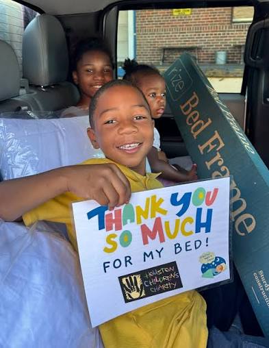Children receiving beds through a community donation program